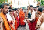 Shishya holding Holy Danda and wearing Kashaya vastra  